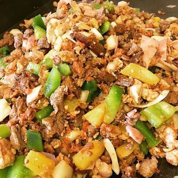 Close-up of Tacos la Gringa's al pastor with pork, pineapple, onions, and green peppers.